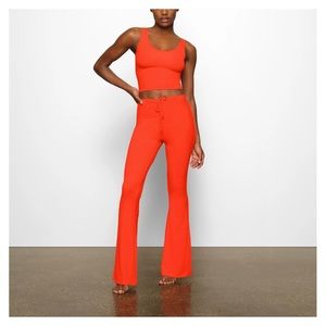 SKIMS Soft lounge top and ruched pants in fire.
